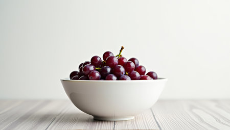Fresh purple grapes in a white ceramic bowl â minimalist and elegant presentationの素材