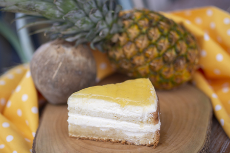 Coconut and pineapple cake on wood with coconut and pineapple backgroundの写真素材
