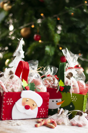 Christmas and New year gifts and baskets with sweets, alcohol, chocolate and cookiesの写真素材