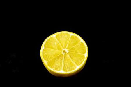 Fresh sliced lemon with isolated black backgroundの写真素材