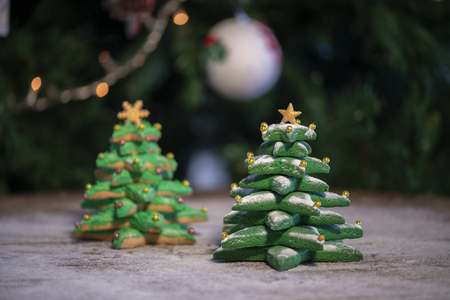 Various Christmas sweet cookies with christmas tree and wood backgroundの写真素材