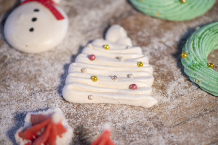 Various Christmas sweet cookies with christmas tree and wood backgroundの写真素材