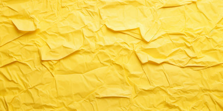 Crumpled yellow paper background. Yellow crumpled paper texture.の素材