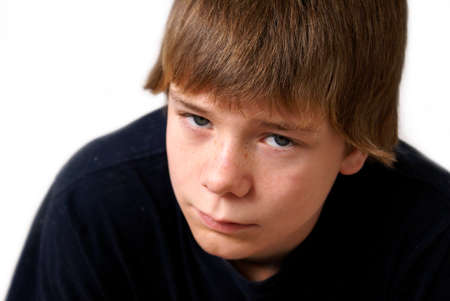 A teen boy looks up to the camera with a troubled expression.の写真素材