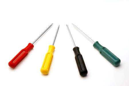 Four colored screwdrivers are isolated over white.