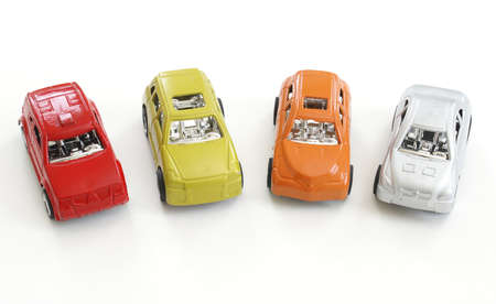 Four different colored toy cars in a row.の写真素材