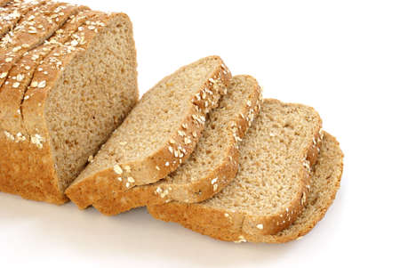 A loaf of honey and oats bread isolated on white.