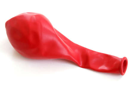 A macro shot a deflated red balloon.の写真素材