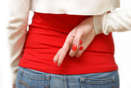 A girl crosses her fingers behind her back.