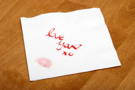 A woman writes a love note on a napkin with her lipstick.の写真素材