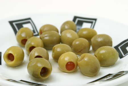 A bunch of green olives on a plate.の写真素材