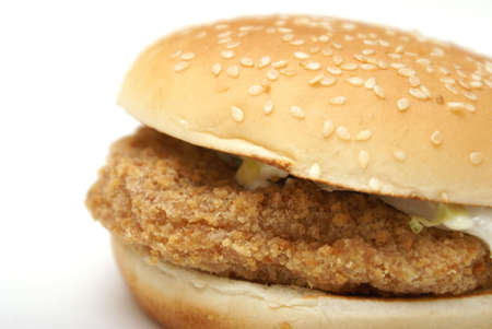 An isolated chicken burger on a sesame seed bun.の写真素材