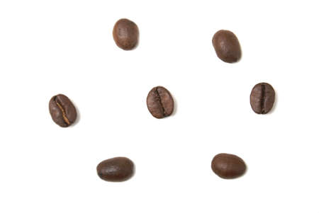 Seven coffee beans isolated on white background.