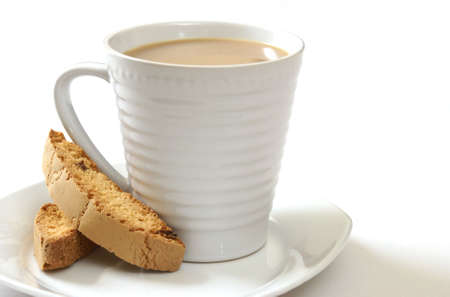 A cup of coffee with some strawberry biscotti.の写真素材