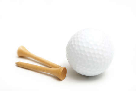 A golf ball and wooden tees are isolated over white.の写真素材