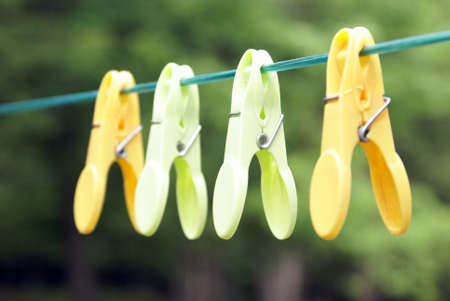 A few clothespins hanging on the line.の写真素材