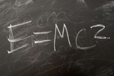 Albert Einsteins famous matematical equation e=mc2 written on a chalkboard.の写真素材