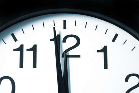 A macro shot of a clock with one minute left to 12. A macro shot of a clock with one minute left to 12.
