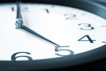 A macro shot of a clock striking five.の写真素材