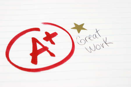 An A plus is given to a student for great work being achieved.の写真素材