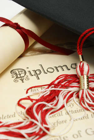 A diploma and grad hat represent a high achieving student.の写真素材