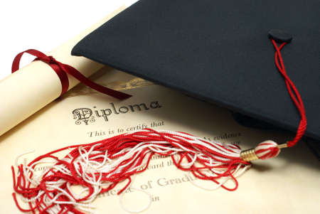 A diploma and grad hat represent a high achieving student.の写真素材