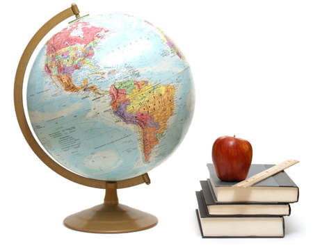 A globe and textbooks for a geography class are isolated on white. A globe and textbooks for a geography class are isolated on white.
