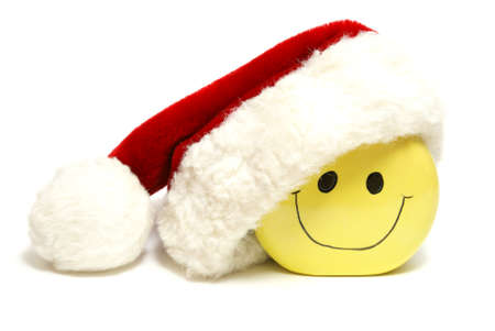 An isolated shot of a smiley face wearing a santa hat for the holiday season.