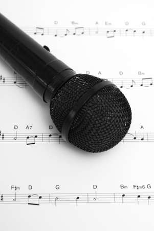 A microphone and sheet music together.  The sheet is an uncopyrighted Christmas carol of The First Noel.の写真素材