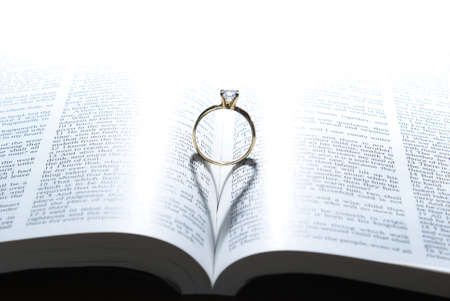 A wedding ring and the light of God, put together, make the symbol of love upon the marriage.の写真素材