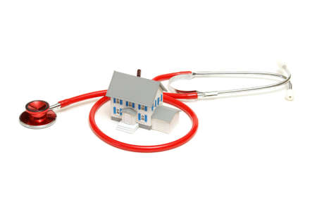 An isolated stethoscope and house represent home nursing or other concepts.の写真素材