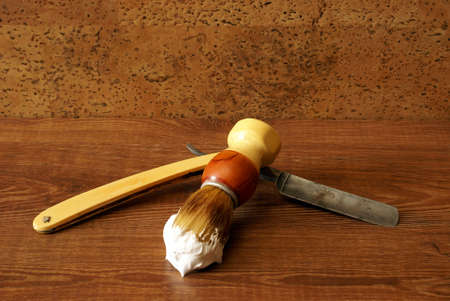 An antique razor and brush for shaving.の写真素材