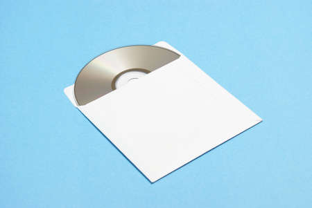 A compact disk is slightly removed from its paper envelope.の写真素材