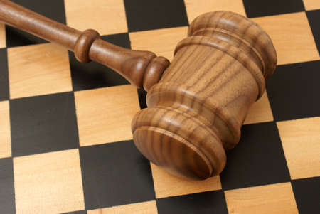 A wooden gavel and chess board represent strategy in legal situations.の写真素材