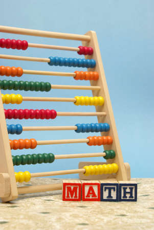 A childs abacus and alphabet blocks to represent the subject of learning math.