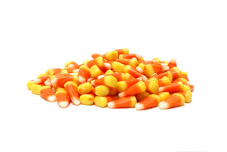 An isolated pile of candy corn for the halloween season.