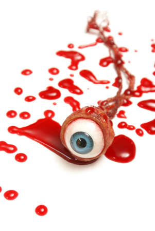 A realistic looking eyeball in a pool of blood over a white background.の写真素材