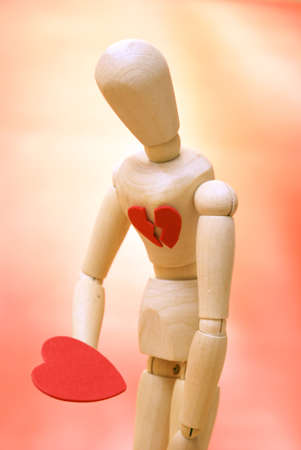 A mannequin looks down to their newly found mended heart.の写真素材