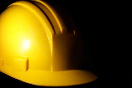A low key shot of a construction workers hardhat for extra security on the job site.の写真素材