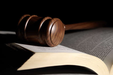 A low key shot of a gavel on a book.
