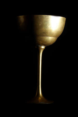 An antique wine cup shot on a low key black background.の写真素材