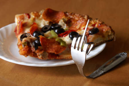 An angry fork gestures his opionion against greasy foods such as pizza.の写真素材