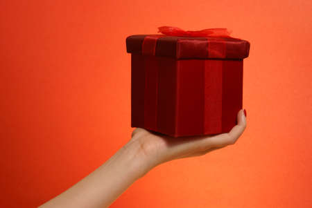 A woman stretches out to give a tiny gift for the occassions that call for giving.の写真素材