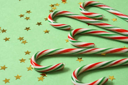 A festive group of delghtful candycanes with star confetti.の写真素材
