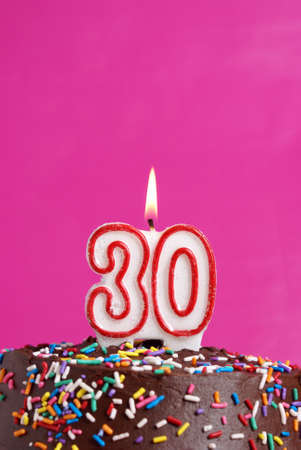 A number candle is lit in celebration of thirty years.の写真素材
