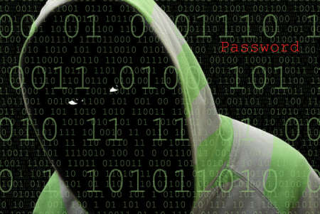 A suspicious male hides in the darkness while hacking computer passwords.