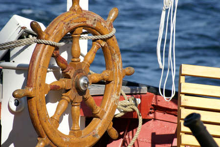 A closeup shot of the helm of a ship in the harbor.の写真素材