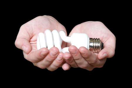 A woman holds a modern eco friendly light bulb in her hands to show embrace.