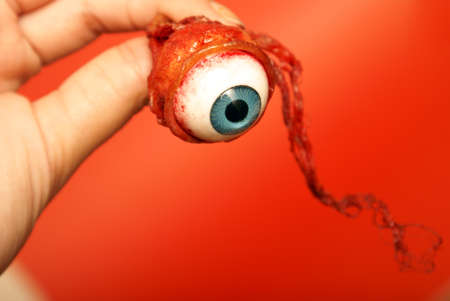 A person holds an eyeball in their hand.の写真素材