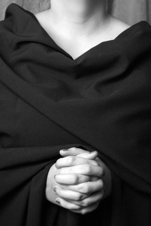 A black and white image of a womans hands clasped in prayer.の写真素材